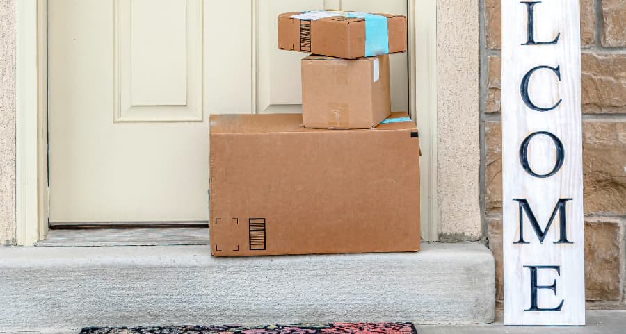 Deliveries on the front porch of a house with a welcome sign in Kalamazoo